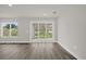 Living room with wood floors, a large glass sliding door, and a large window at 501 Dean Creek Ln, Orlando, FL 32825