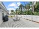 Spacious wooden deck, perfect for outdoor dining and relaxation overlooking the fenced backyard at 516 8Th St, Orlando, FL 32820