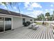 Exterior view of the backyard featuring a deck with a grill and a dining table at 516 8Th St, Orlando, FL 32820