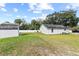 The spacious backyard features a lush lawn, a white fence, and a storage shed at 516 8Th St, Orlando, FL 32820