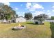 Expansive backyard featuring a cozy fire pit, outbuilding, a large deck, and lush green lawn at 516 8Th St, Orlando, FL 32820