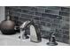 Chrome bathroom sink fixtures with soap dispenser and gray tiled backsplash at 516 8Th St, Orlando, FL 32820