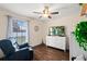 Relaxing bedroom with wood-look floors, comfortable chair, and a large window providing ample natural light at 516 8Th St, Orlando, FL 32820