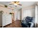 Cozy bedroom featuring a chair, dresser, and wood-look flooring creating a relaxing atmosphere at 516 8Th St, Orlando, FL 32820