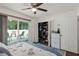 Bright bedroom with sliding doors to the deck, ceiling fan, and organized closet and dresser at 516 8Th St, Orlando, FL 32820