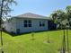 Expansive backyard with well-maintained lawn, young trees and landscaping offering a serene outdoor space at 5179 Royal Point Ave, Kissimmee, FL 34746