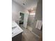 Well-lit bathroom featuring a glass shower, granite countertops, and access to the bedroom at 5179 Royal Point Ave, Kissimmee, FL 34746