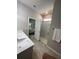 Well-lit bathroom featuring a glass shower, granite countertops, and access to the bedroom at 5179 Royal Point Ave, Kissimmee, FL 34746