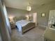 Bedroom featuring a plush bed with decorative pillows, a neutral color scheme, and soft ambient lighting at 5179 Royal Point Ave, Kissimmee, FL 34746