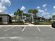 Scenic community park features palm trees, walking paths, and a covered picnic area under a beautiful blue sky at 5179 Royal Point Ave, Kissimmee, FL 34746