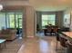 Open living area with tile flooring connecting the living room and dining room, showcasing a modern design at 5179 Royal Point Ave, Kissimmee, FL 34746