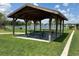 Community park shelter with picnic tables overlooking tranquil lake, for relaxing outdoor gatherings at 5179 Royal Point Ave, Kissimmee, FL 34746