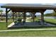 Outdoor picnic shelter with tables, benches, and lake views for relaxation and recreation at 5179 Royal Point Ave, Kissimmee, FL 34746