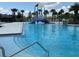 Community pool with walk-in steps, slide, and shallow splash pad for recreational use at 5179 Royal Point Ave, Kissimmee, FL 34746