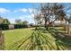 Spacious backyard showcasing mature trees, a well-maintained lawn, and a fenced perimeter at 52 Bay Ridge Loop, Mascotte, FL 34753