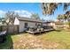 Backyard featuring a deck with outdoor seating, a pergola, and a grill, perfect for entertaining at 52 Bay Ridge Loop, Mascotte, FL 34753