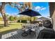 Outdoor living on spacious deck with large backyard and patio seating under a large shade umbrella at 52 Bay Ridge Loop, Mascotte, FL 34753