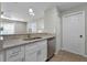 Stylish kitchen with granite countertops, stainless steel dishwasher, and white cabinets at 52 Bay Ridge Loop, Mascotte, FL 34753