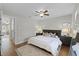 Bright main bedroom featuring a ceiling fan, bedside tables, and a comfortable king-size bed at 52 Bay Ridge Loop, Mascotte, FL 34753