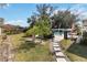 Lush backyard featuring a swimming pool with manicured landscaping and stone pathways at 5359 Lanyard Ct, Winter Park, FL 32792