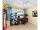 Cozy bedroom showcasing a well-lit workspace, window and a decorative screen, perfect for a home office or study at 5359 Lanyard Ct, Winter Park, FL 32792