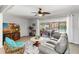 Comfortable living room with a ceiling fan, tile flooring, and sliding glass doors to the patio at 5359 Lanyard Ct, Winter Park, FL 32792