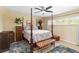 Spacious main bedroom with a four poster bed, ceiling fan and tile flooring at 5359 Lanyard Ct, Winter Park, FL 32792