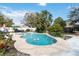 Beautiful backyard pool with landscaping, patio furniture, and pink flamingo floats at 5359 Lanyard Ct, Winter Park, FL 32792