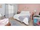 Cozy bedroom with soft pink walls, plush bedding, and a serene atmosphere at 5590 Forest Ridge Dr, Winter Haven, FL 33881