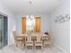 Bright dining room features a chandelier, wood table and chairs, and sliding glass doors at 5590 Forest Ridge Dr, Winter Haven, FL 33881