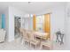 Bright dining room features a chandelier, wood table and chairs, and sliding glass doors at 5590 Forest Ridge Dr, Winter Haven, FL 33881