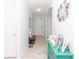 Inviting hallway with tile flooring, arched doorway, decorative console table, and modern decor at 5590 Forest Ridge Dr, Winter Haven, FL 33881