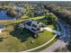 Aerial view featuring a manicured lawn, palm trees, and a screened pool enclosure, creating a serene outdoor space at 642 Osprey Lakes Cir, Chuluota, FL 32766