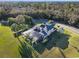 Aerial view of a spacious home with a screened-in pool area and expansive green lawn at 642 Osprey Lakes Cir, Chuluota, FL 32766