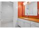 Modern bathroom featuring orange tile, white cabinets, and a bathtub at 642 Osprey Lakes Cir, Chuluota, FL 32766