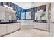 Stylish bathroom featuring blue tiled walls, double vanity, and a luxurious soaking tub by the window at 642 Osprey Lakes Cir, Chuluota, FL 32766