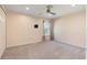 Spacious bedroom with neutral carpet, a ceiling fan, and a window with curtains at 642 Osprey Lakes Cir, Chuluota, FL 32766