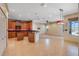 Well-lit eat-in kitchen with wood cabinets, tile flooring and black countertops at 642 Osprey Lakes Cir, Chuluota, FL 32766