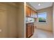 Functional laundry room with sink, tile floors, and storage cabinets at 642 Osprey Lakes Cir, Chuluota, FL 32766