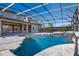 This is an angled view of the screened in pool with interlock stone decking and hot tub at 642 Osprey Lakes Cir, Chuluota, FL 32766