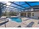 Outdoor swimming pool and spa with screened enclosure and patio area at 642 Osprey Lakes Cir, Chuluota, FL 32766