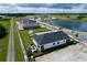 An aerial view of a new construction home with a fire pit in the backyard, near a pond at 6825 Yellow Warbler Bnd, St Cloud, FL 34773