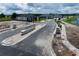 Image of the community entrance featuring landscaped medians and newly built homes in the background at 6825 Yellow Warbler Bnd, St Cloud, FL 34773