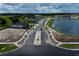 Street view of the community entrance showcasing landscaping, ponds and newly constructed homes at 6825 Yellow Warbler Bnd, St Cloud, FL 34773