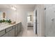 Bright bathroom with double vanity sinks, quartz countertop, tile flooring and a shower in the background at 7054 Rosy Sky Ave, Orlando, FL 32829