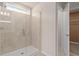 Modern bathroom featuring a tiled walk-in shower and glass door at 7054 Rosy Sky Ave, Orlando, FL 32829