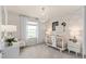 Bedroom room featuring a crib, rocking chair, and calming cloud wallpaper at 7054 Rosy Sky Ave, Orlando, FL 32829