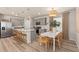 Kitchen area with stainless steel appliances, a kitchen island, and a breakfast table in an open floor plan at 7054 Rosy Sky Ave, Orlando, FL 32829