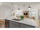 Open concept view from the kitchen, displaying stainless steel appliances and the living room's stylish accents at 7054 Rosy Sky Ave, Orlando, FL 32829