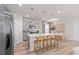 Kitchen with an island that doubles as a breakfast bar, pendant lighting, and stainless steel appliances at 7054 Rosy Sky Ave, Orlando, FL 32829